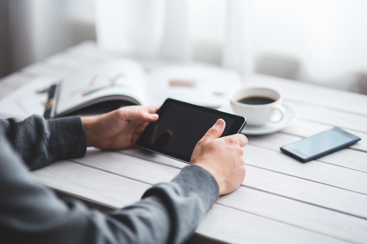 man holds digital tablet in his hands